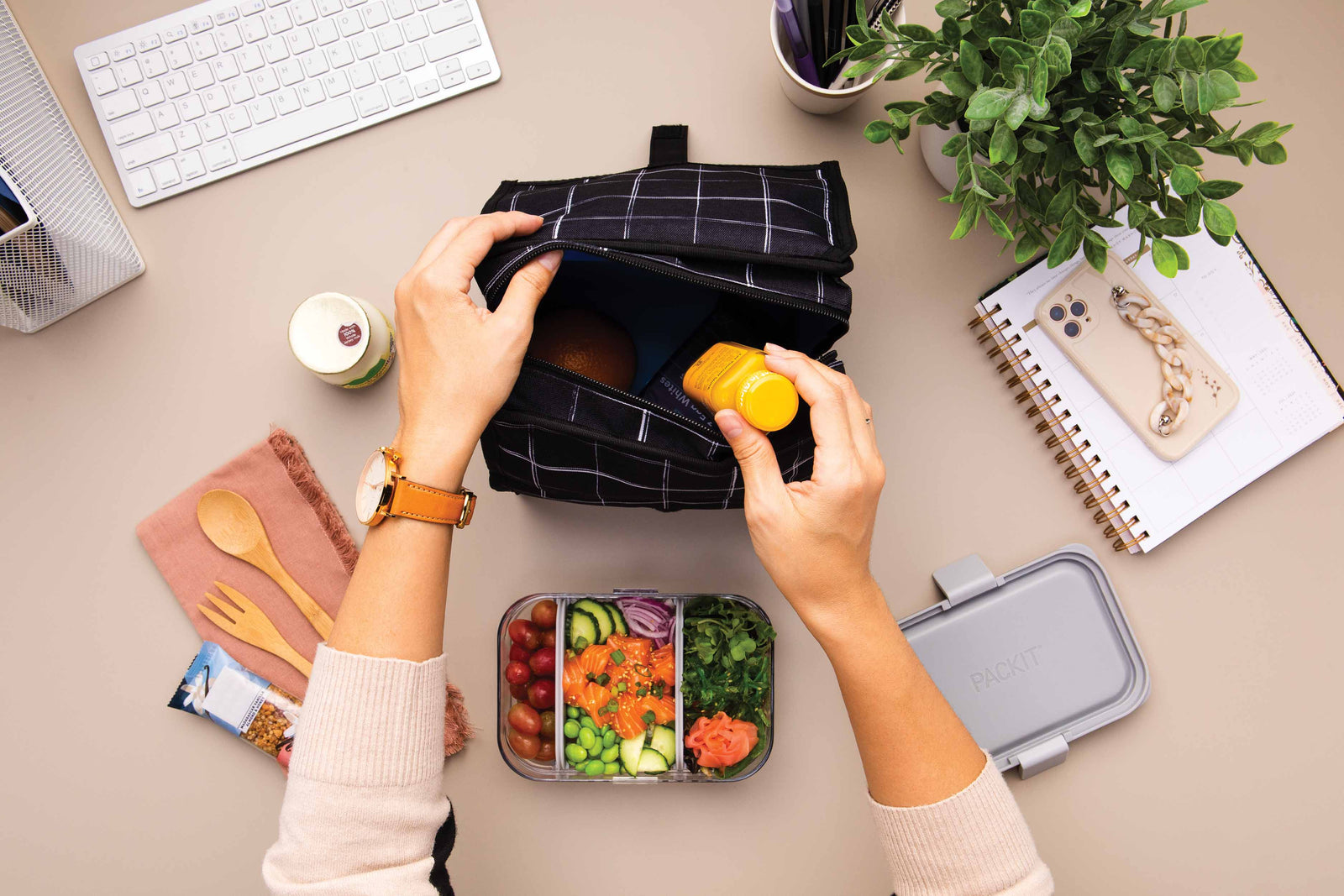 https://packit.com/cdn/shop/articles/freezable-lunch-bag-black-grid-lifestyle-office-lunch.jpg?v=1700179373&width=1600